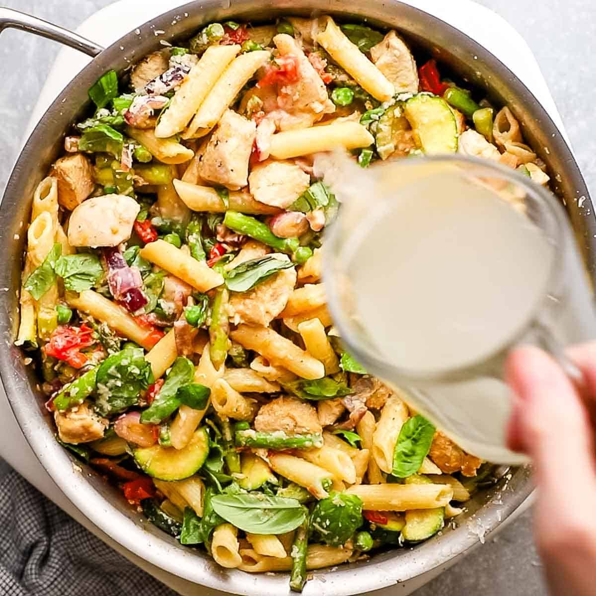 adding reserved pasta water to the skillet