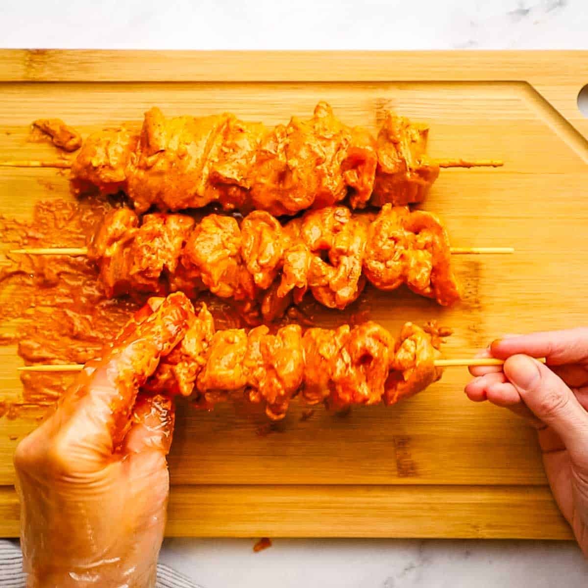 threading the chicken on skewers