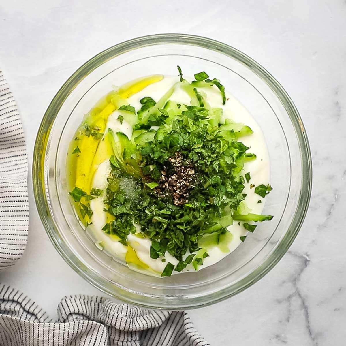 mixing together ingredients for raita dipping sauce