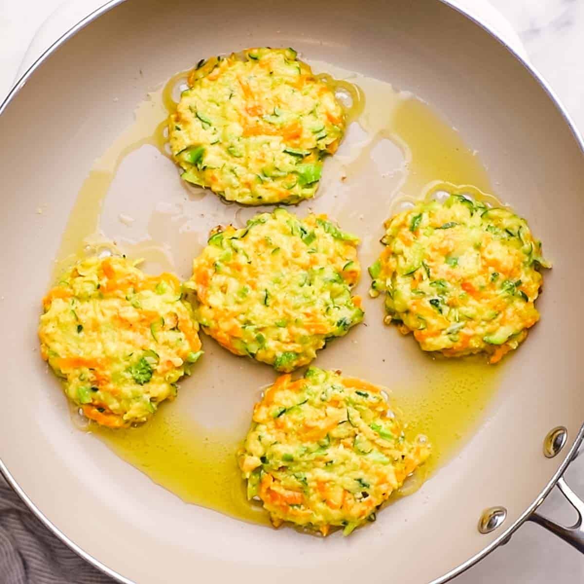 vegetable fritters cooking in a pan