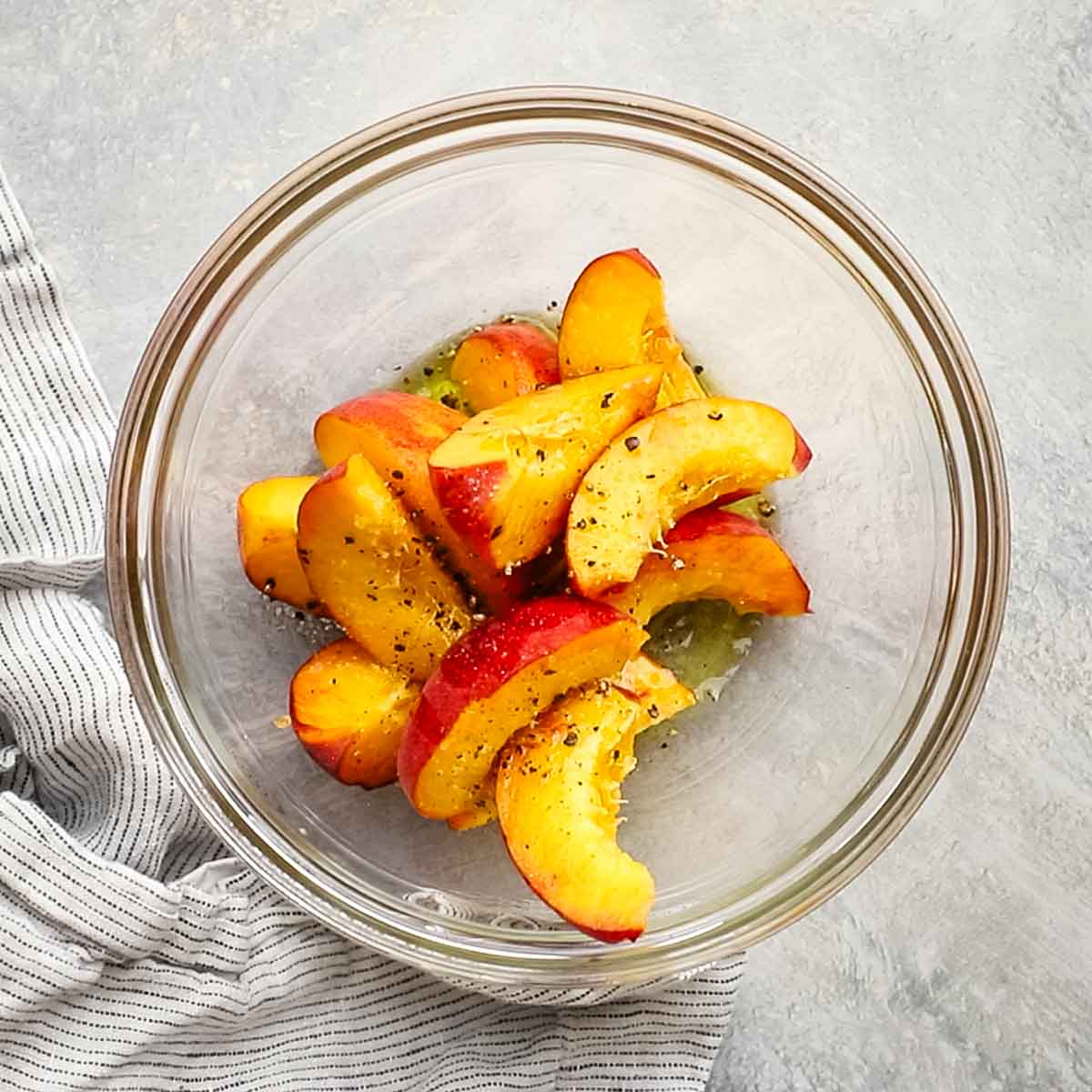 sliced peaches with salt, pepper, and olive oil
