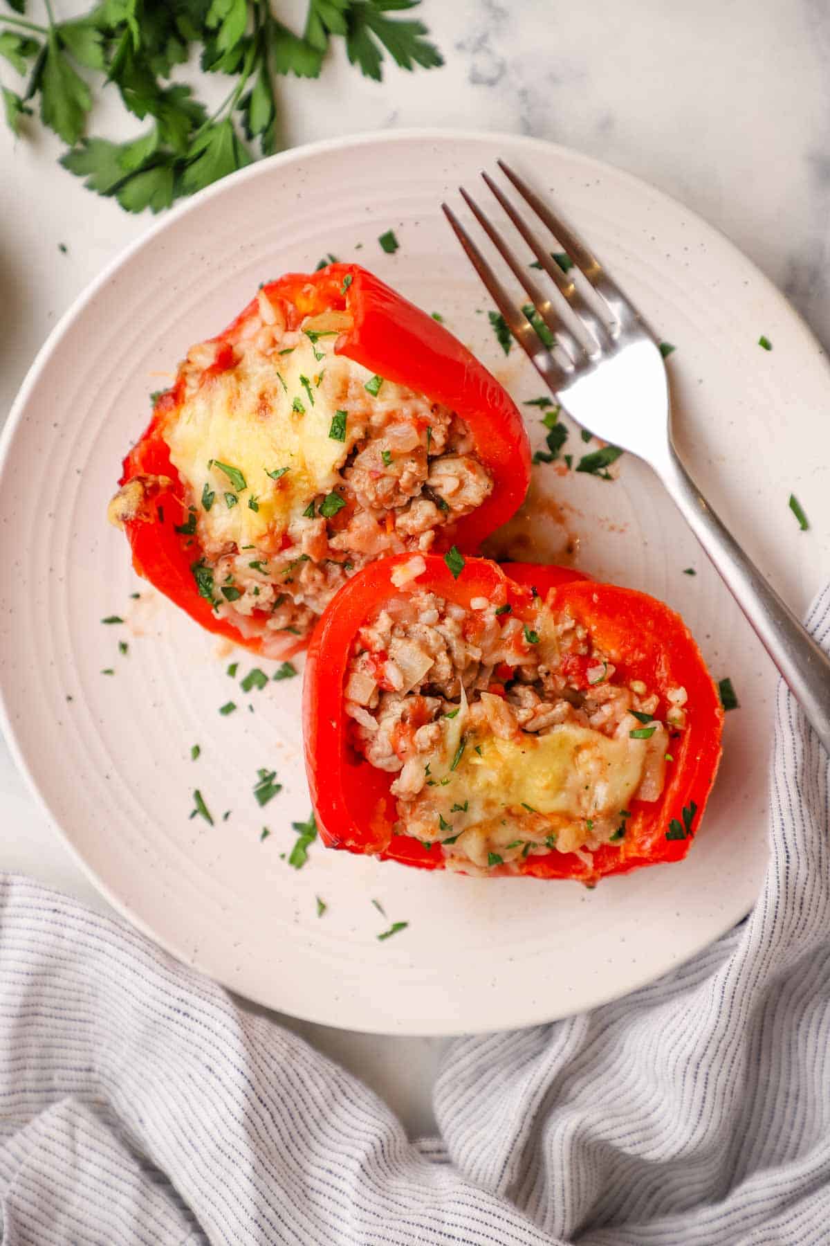 overhead view of two pieces of stuffed bell peppers on a plate.