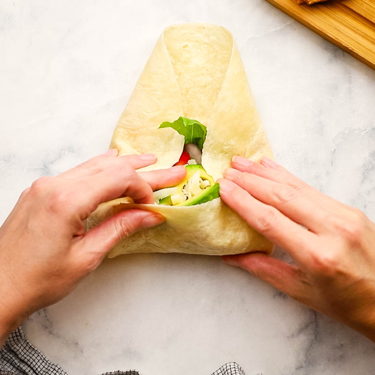 wrapping the tortilla to make the wrap