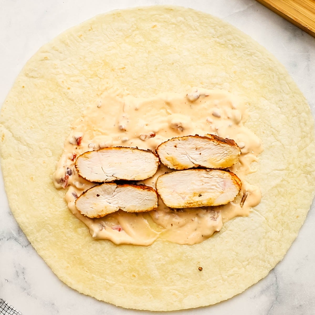 chicken breast placed on the chipotle mayo