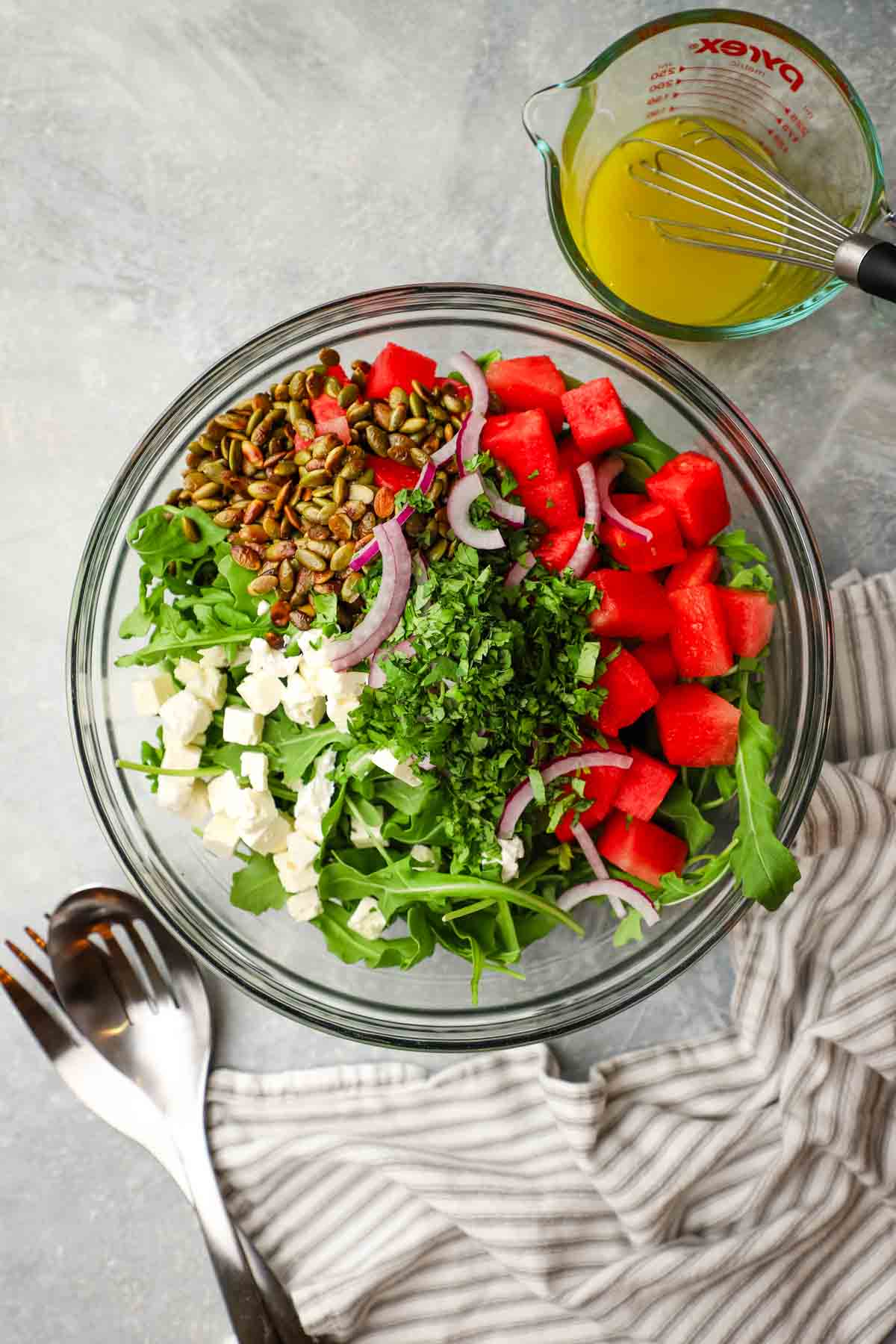 overhead view of a bowl of mexican watermelon salad with the dressing on the side