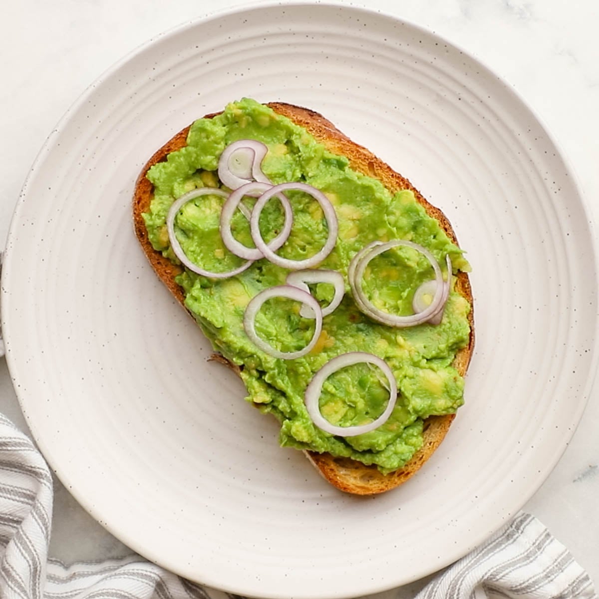 shallots added on top of avocado mixture