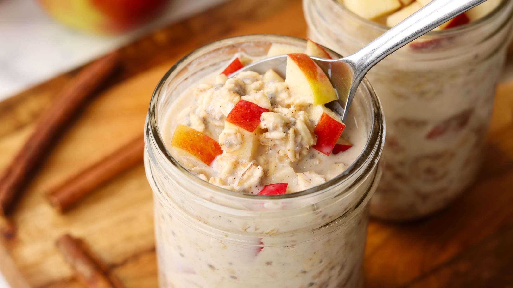 dipping spoon in a jar of apple cinnamon overnight oats