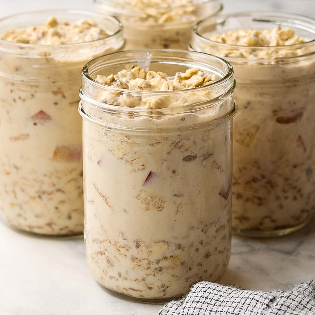 overnight oats mixture divided in four mason jars