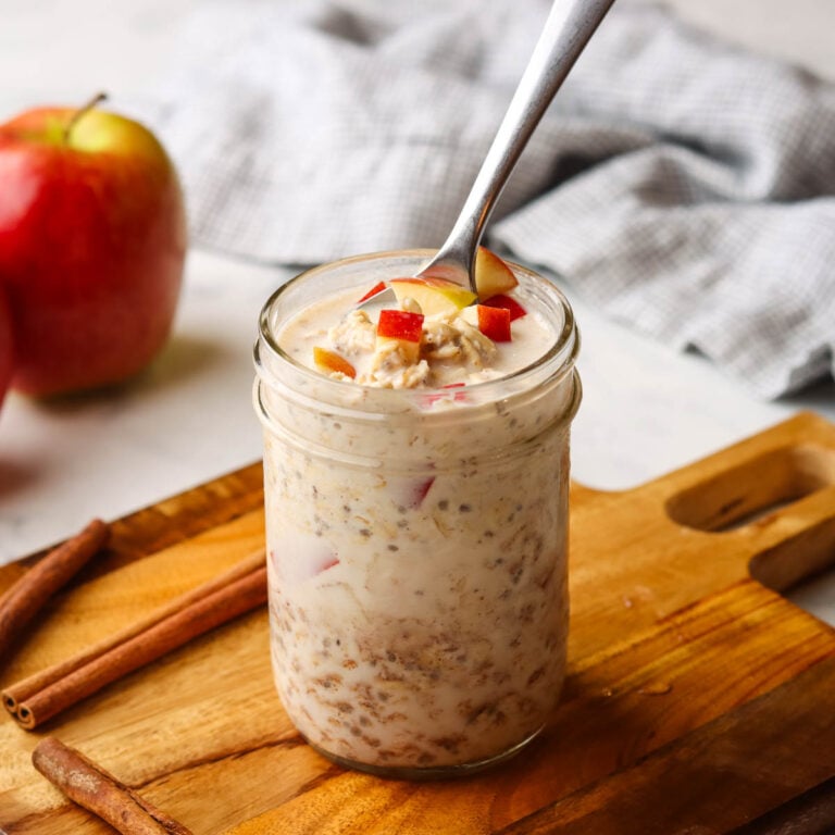 a jar of apple cinnamon overnight oats with a spoon in it