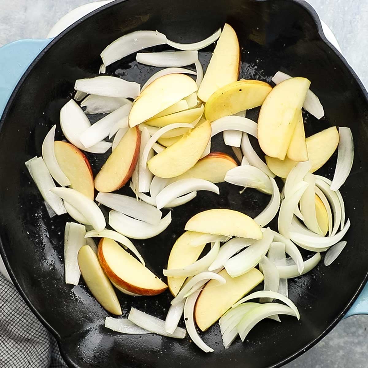 apples and onions added to the skillet