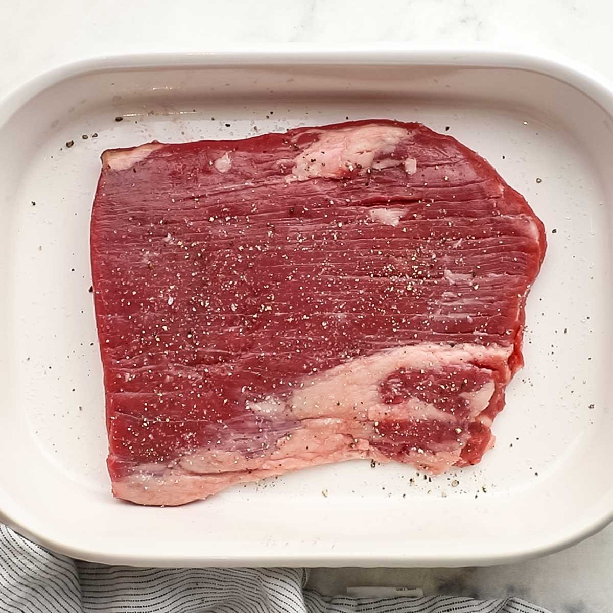 steak with salt and pepper on it