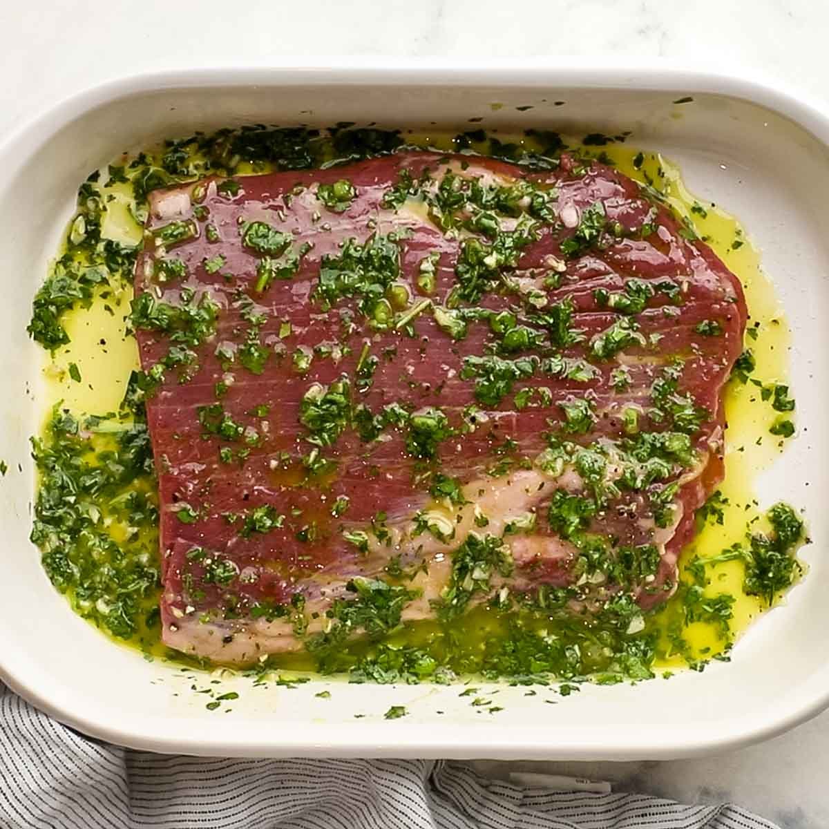 chimichurri sauce in a baking dish with steak