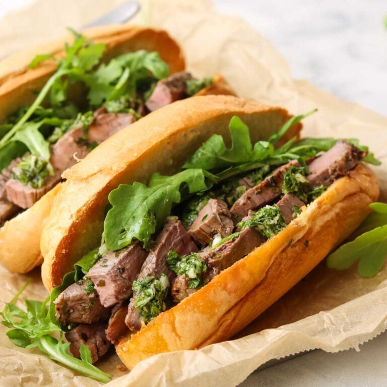 two steak sandwiches with chimichurri
