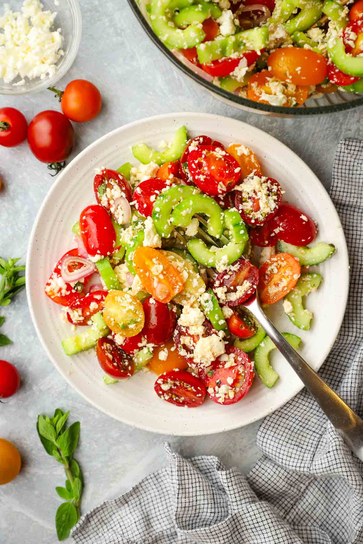 tomato cucumber and feta salad served on a plate.