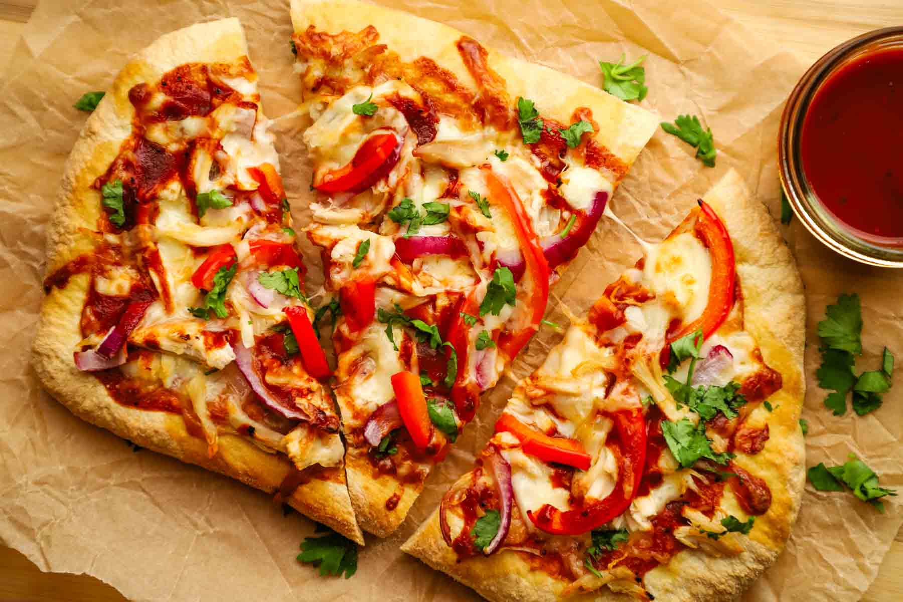 A sliced BBQ chicken flatbread.