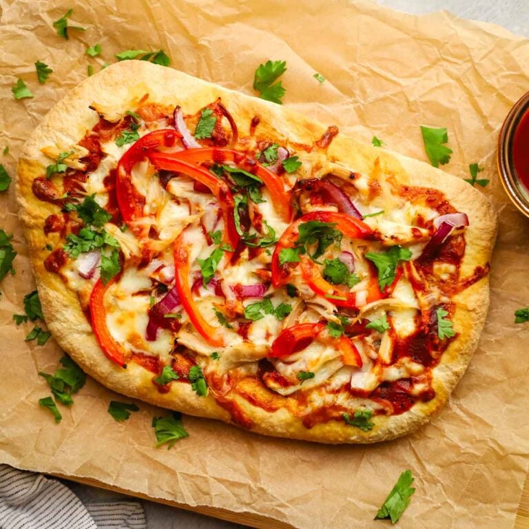 overhead view of a bbq chicken flatbread on a parchment paper