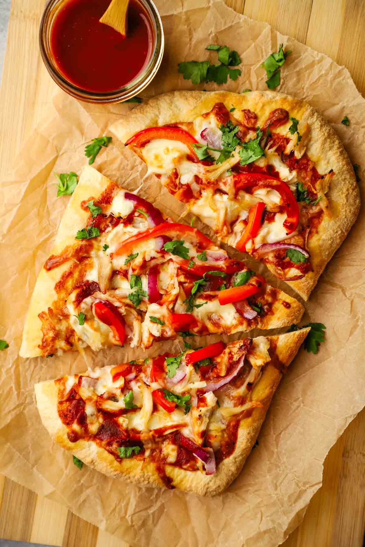 overhead view of a bbq chicken flatbread cut into slices.