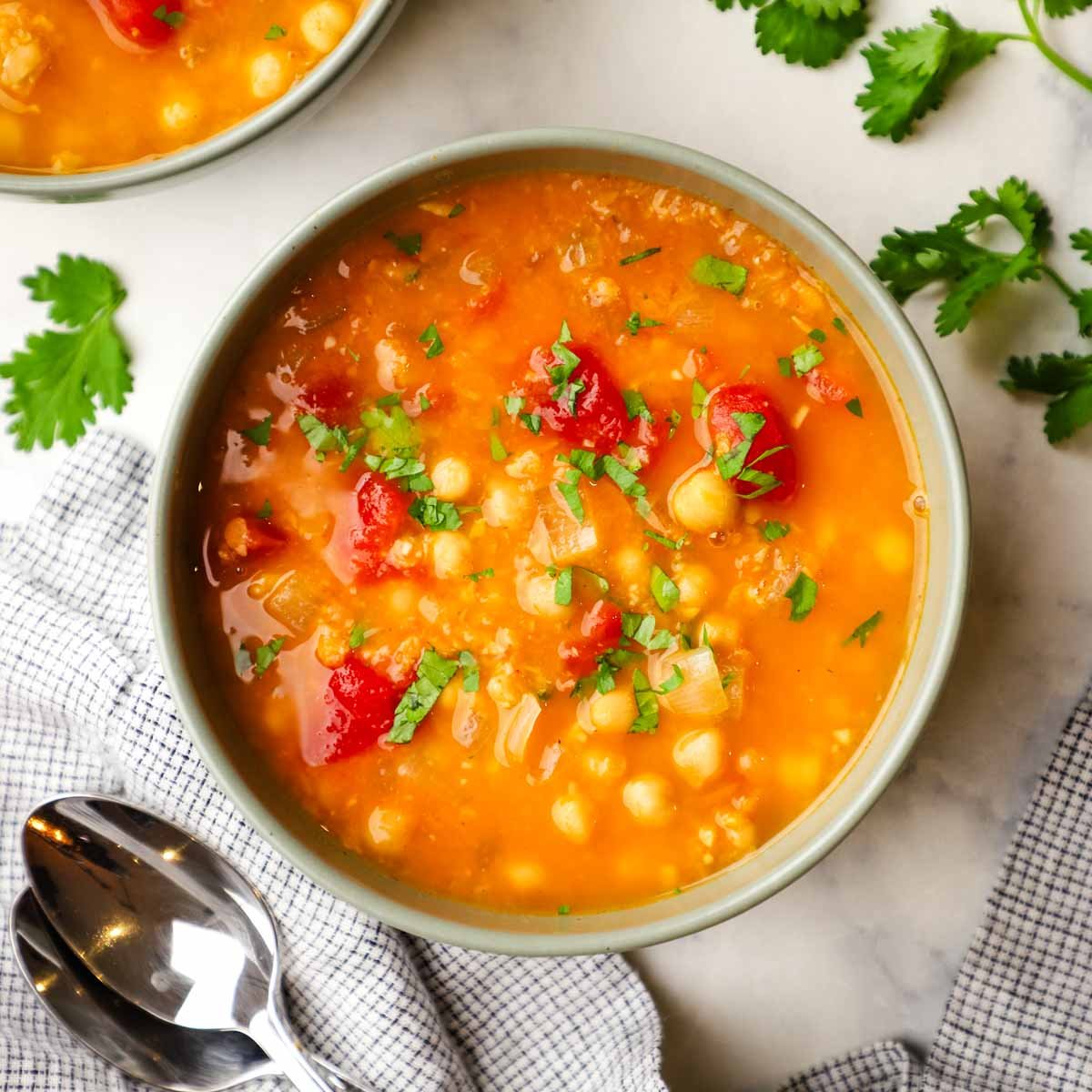 overhead view of a bowl of lentil and chickpea soup