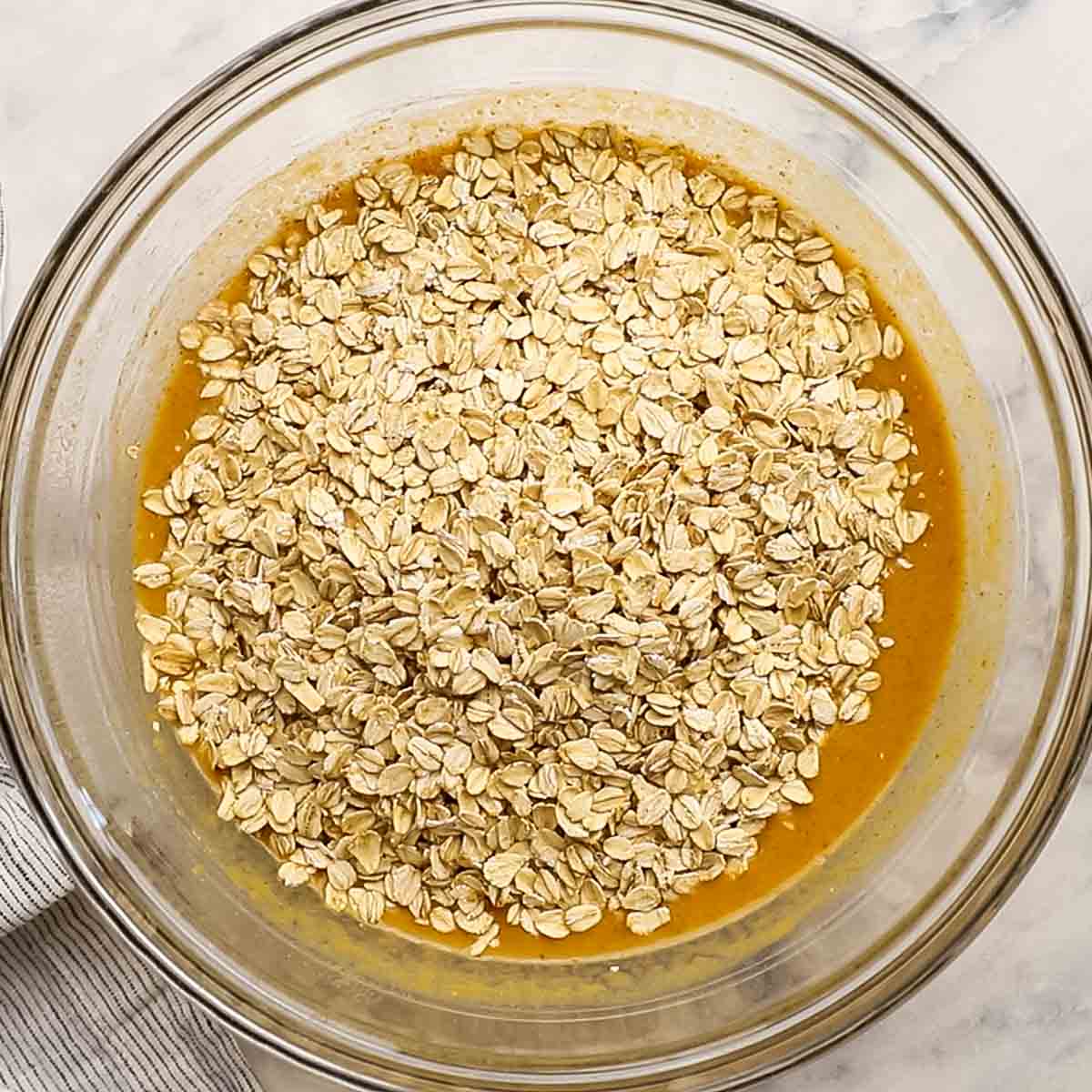 oats added to the wet ingredients in the bowl
