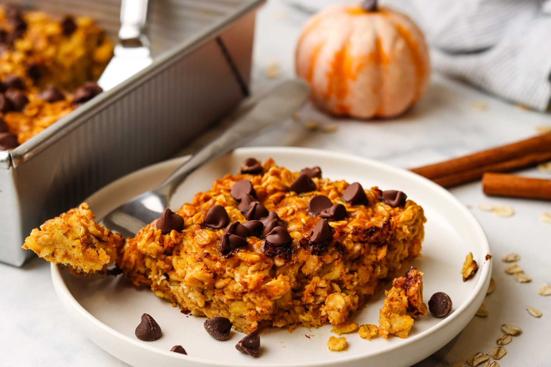 A square of baked pumpkin oats on a plate.