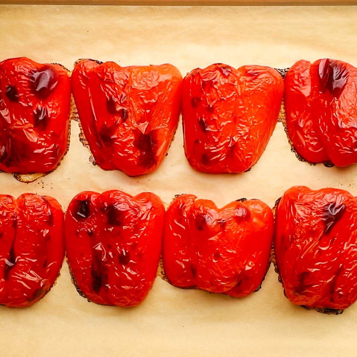 roasted red bell peppers on a baking sheet