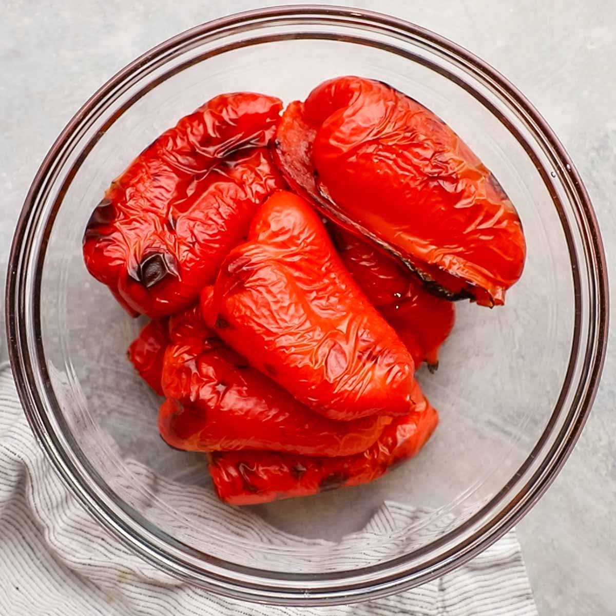 roasted red bell peppers in a glass bowl