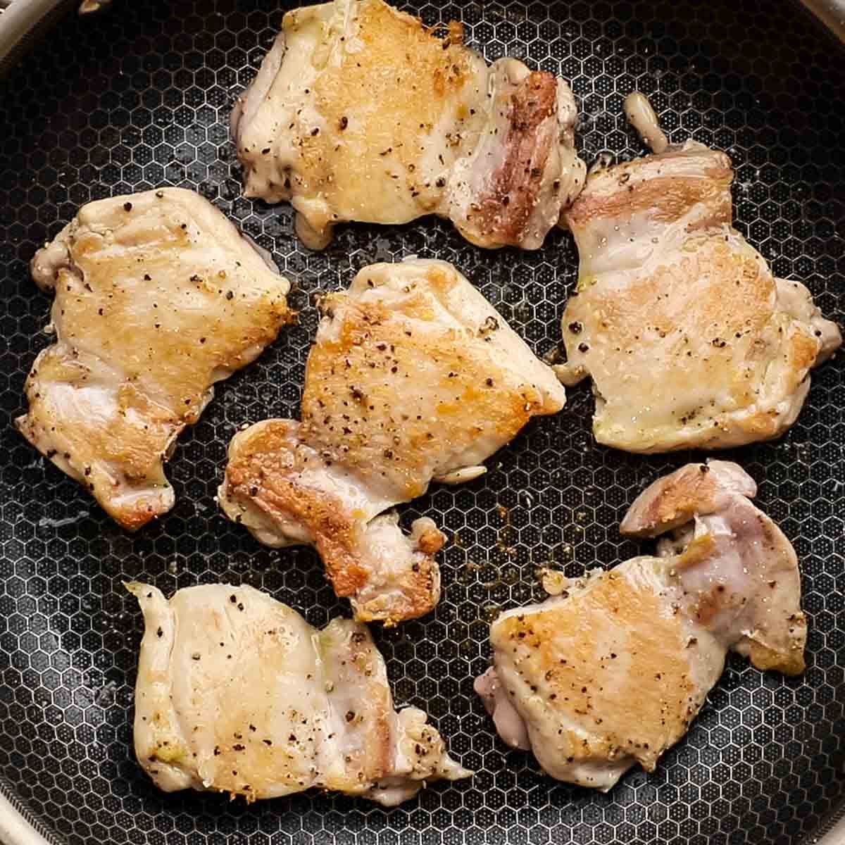 cooking chicken thighs in a skillet