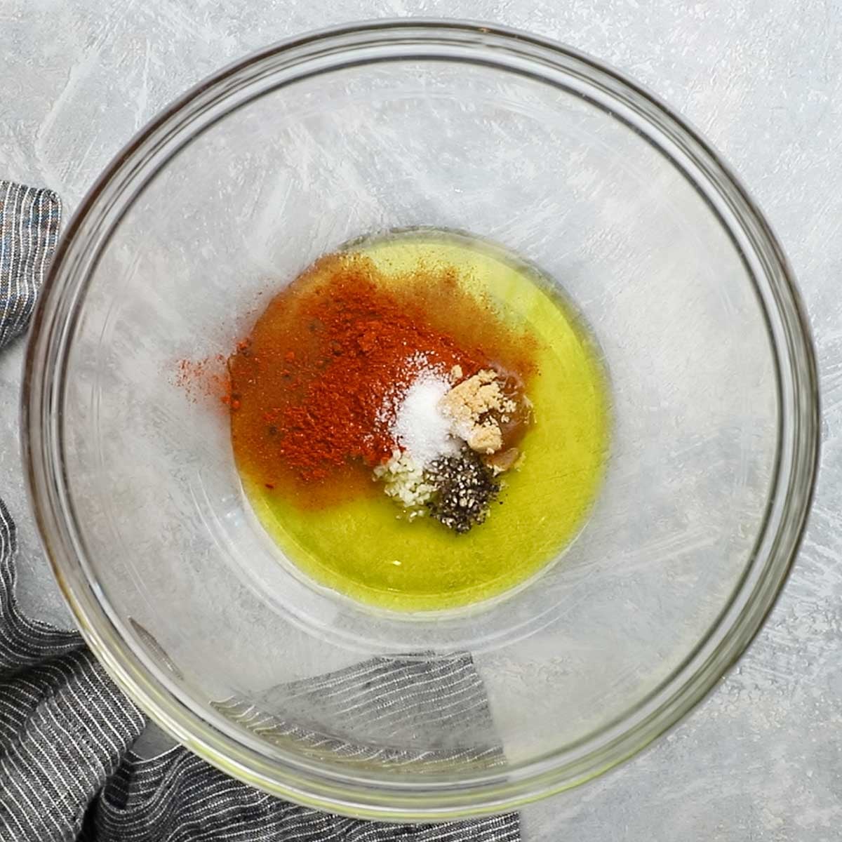 olive oil and seasonings added in a large bowl