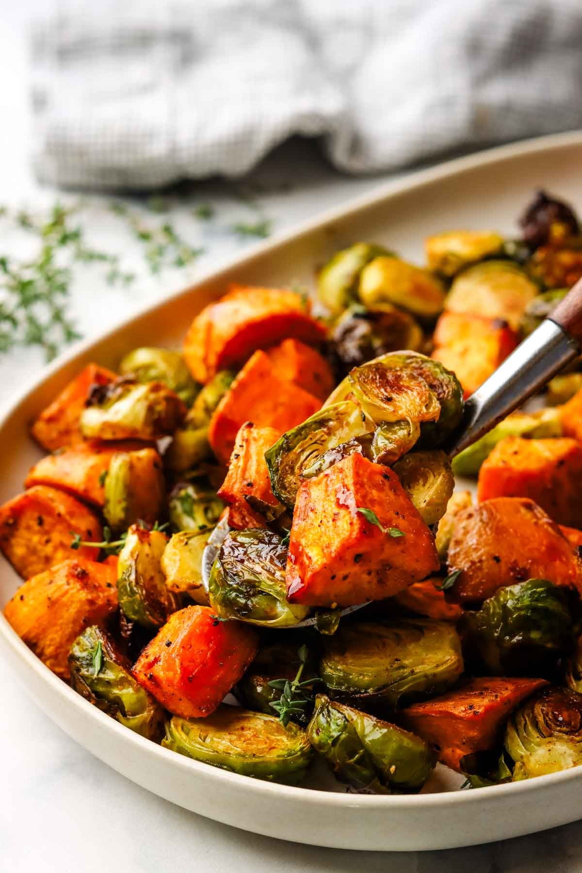 roasted Brussels sprouts and sweet potatoes in a serving bowl