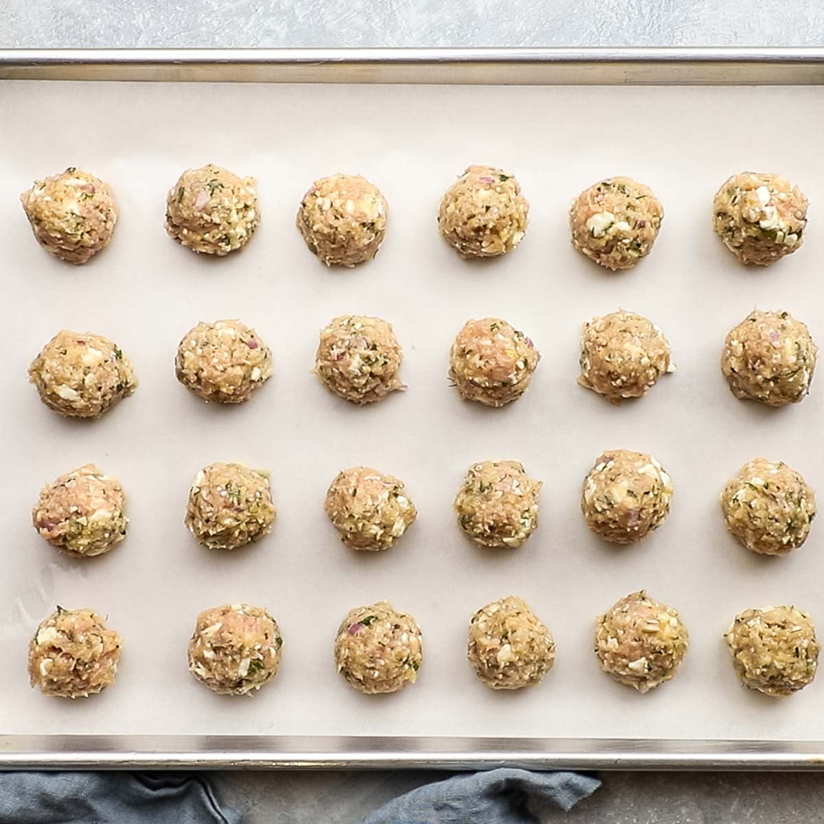 meatballs placed on a baking sheet