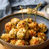 a bowl of chicken feta meatballs with toothpicks in it