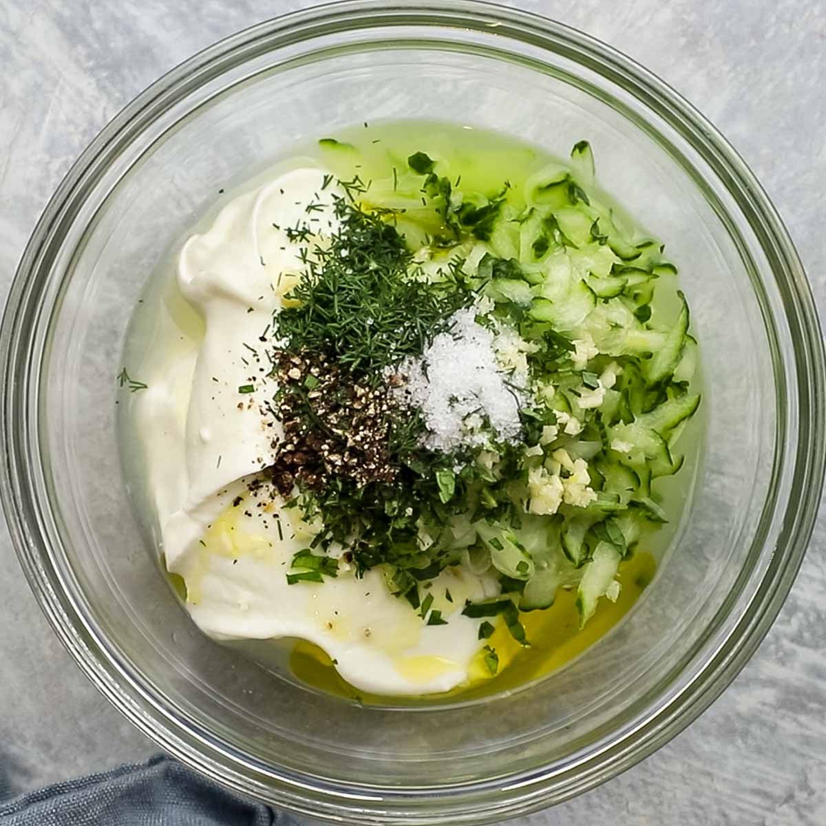 all ingredients for cucumber yogurt dip in a bowl