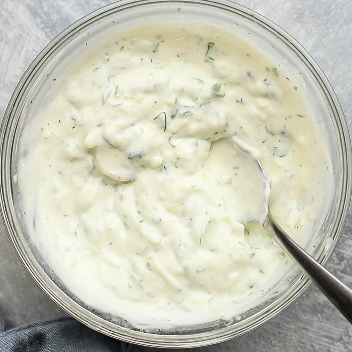 ingredients for cucumber yogurt dip mixed together in a bowl