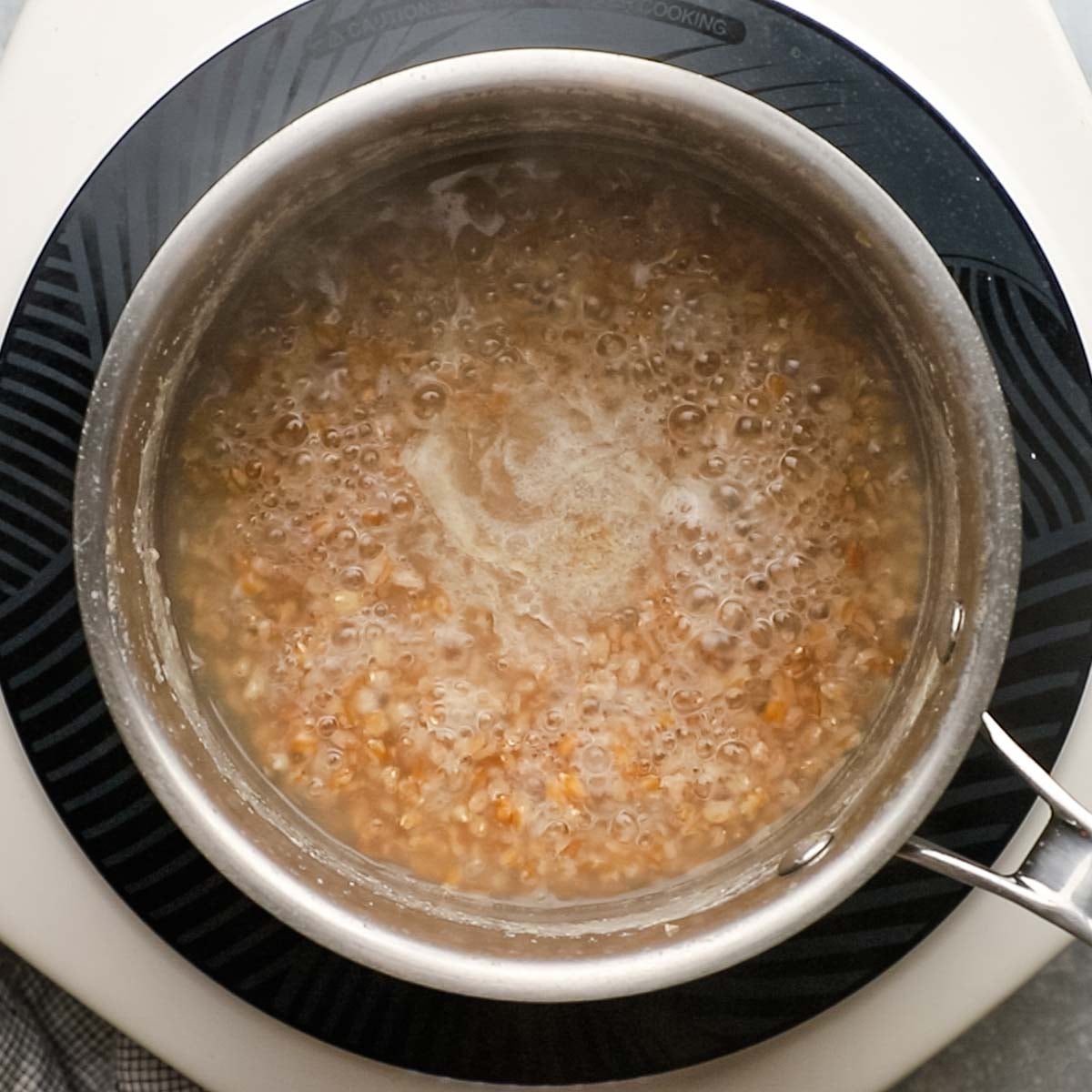 farro grains being boiled in water