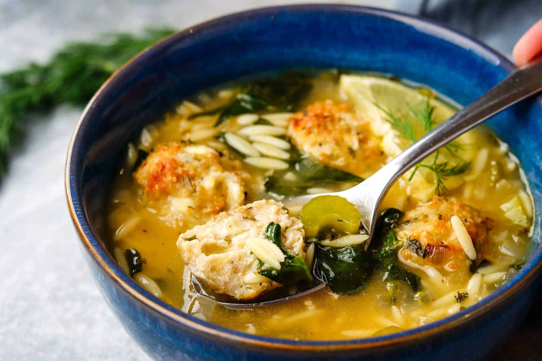A spoonful of chicken meatball soup.