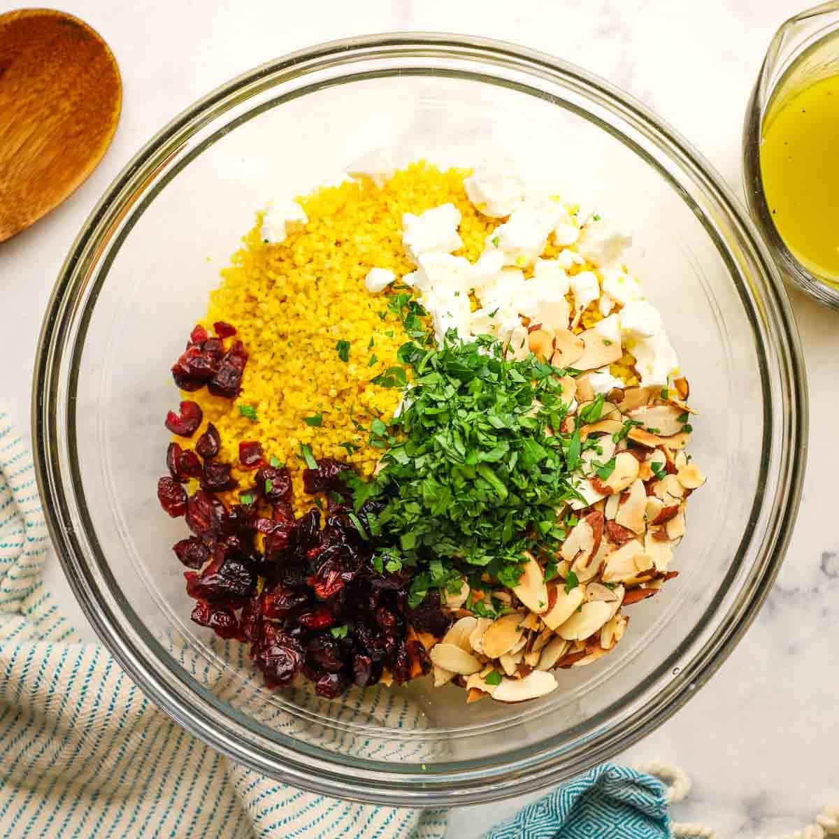 A bowl of ingredients to make couscous salad.