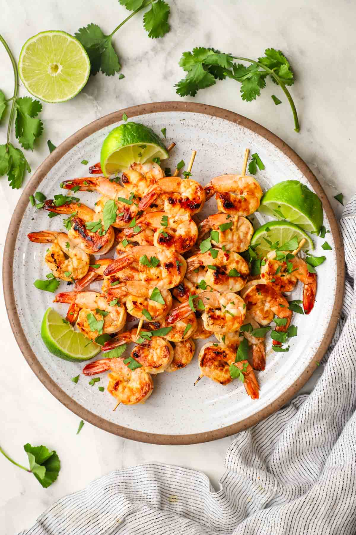 a plate of chili lime shrimp skewers.