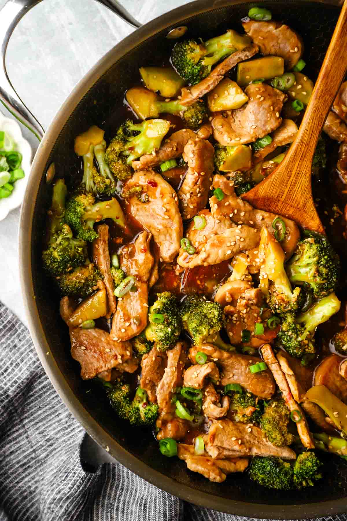 A pan of pork and broccoli stir fry.