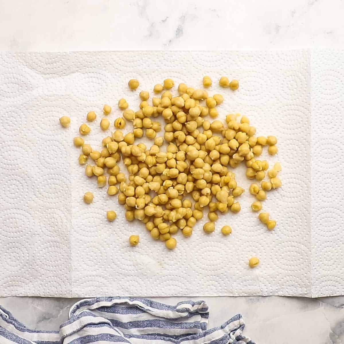 canned chickpeas drying on a paper towel