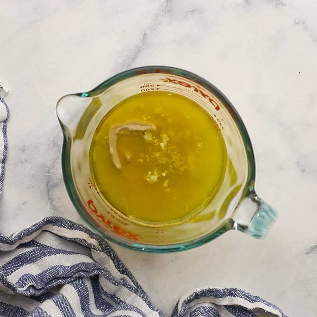 ingredients for the lemon tahini dressing in a measuring cup