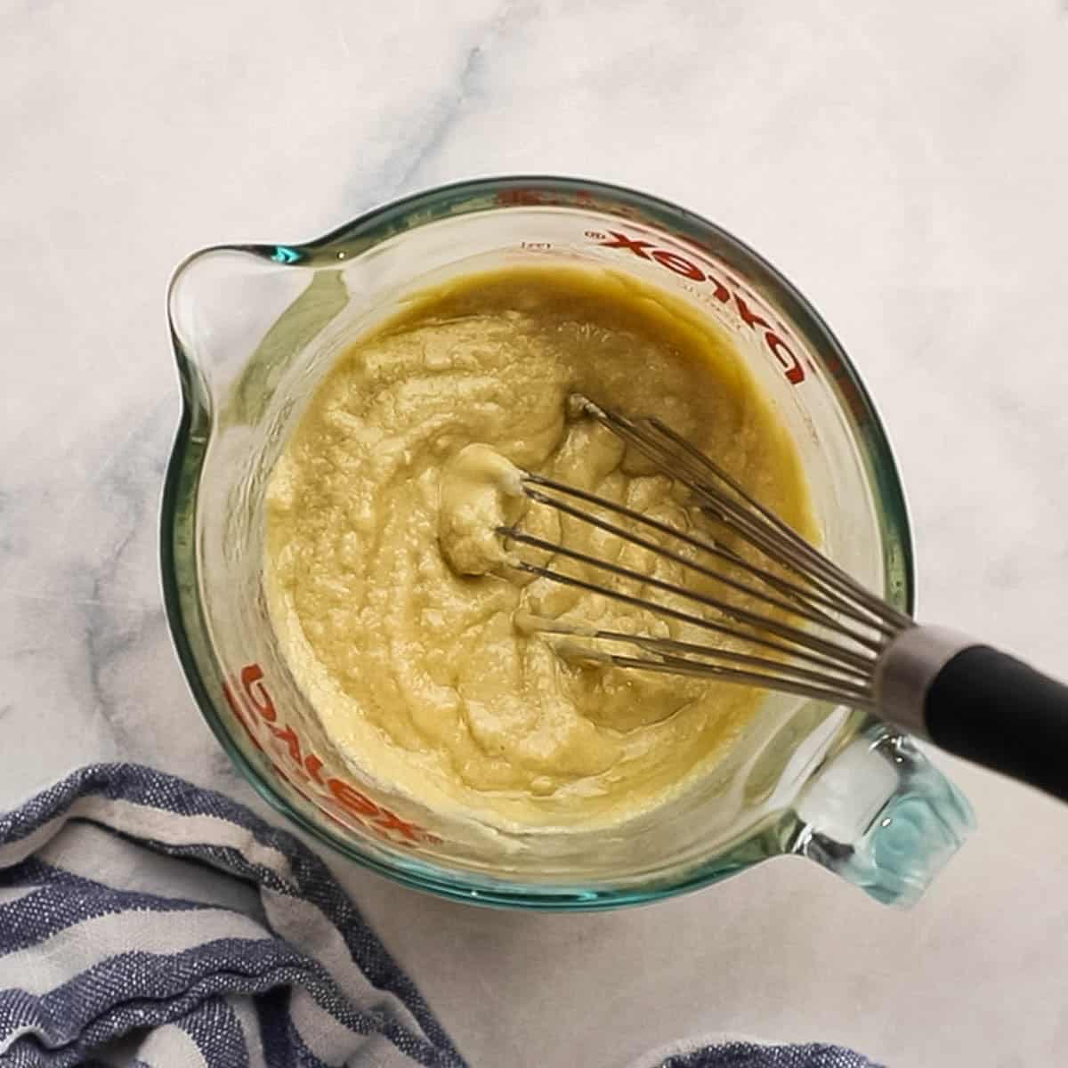 whisking the lemon tahini dressing