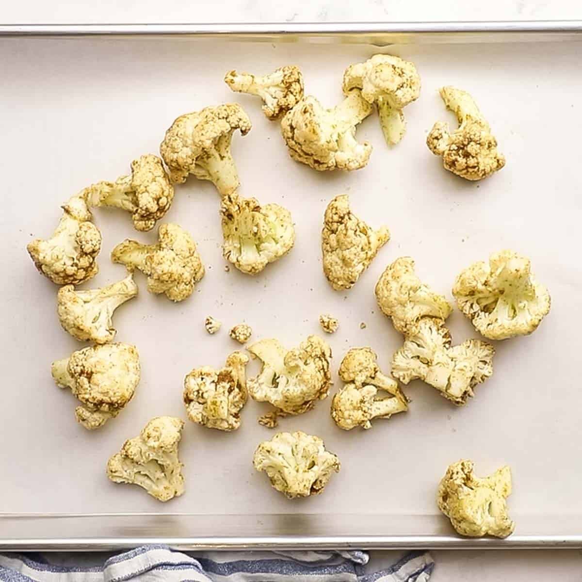 cauliflower florets spread on a baking sheet