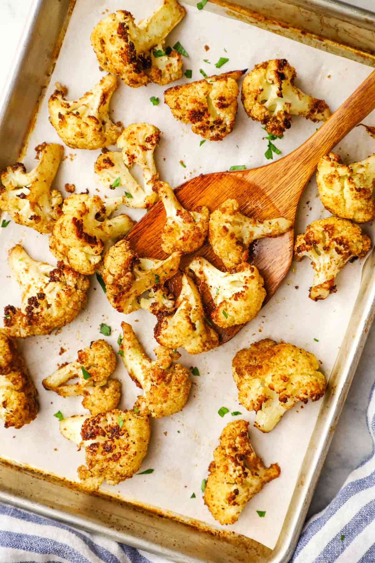 Roasted cauliflower florets on a baking sheet.