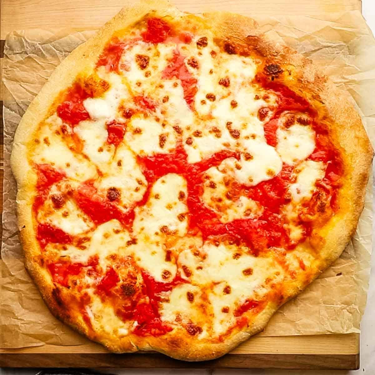 A whole cheese and tomato pizza.