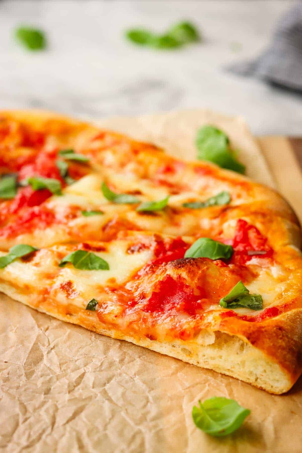 Pizza on homemade pizza thin slice pizza crust on a wooden board.