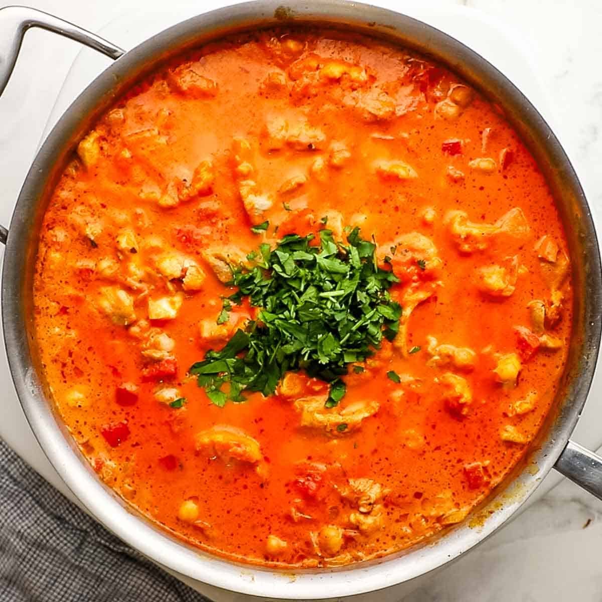 Lime juice and cilantro added to the pan of simmering ingredients and gently stirred.