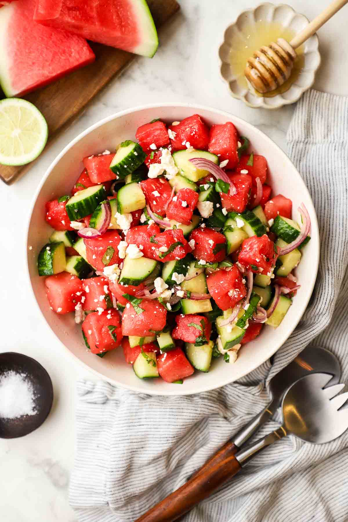 Cucumber Watermelon salad garnished with some mint inside a serving bowl, ready to be served.