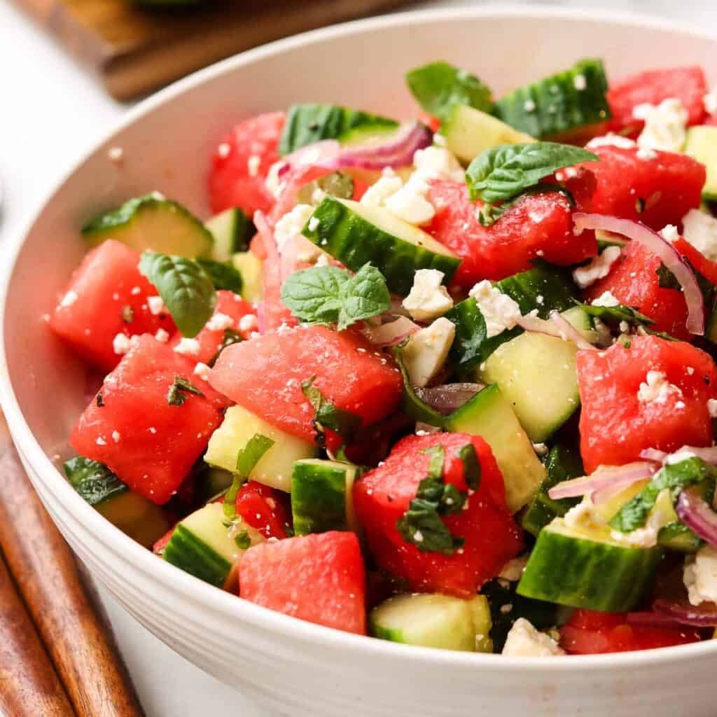 A bowl of cucumber watermelon salad.