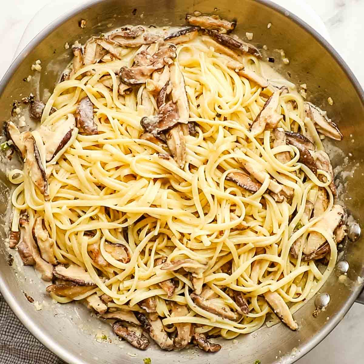 Pasta and a little bit of pasta water added to the skillet that contains the mushrooms, and cream and gently stirred.