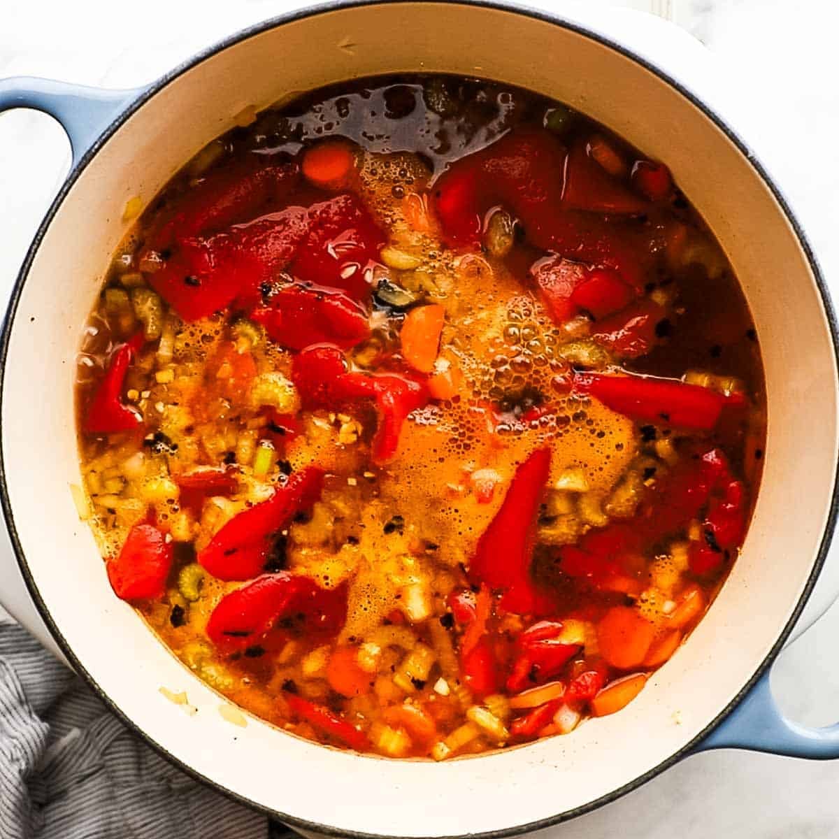 Broth, paprika added to the peppers, and onion mixture in the dutch oven.